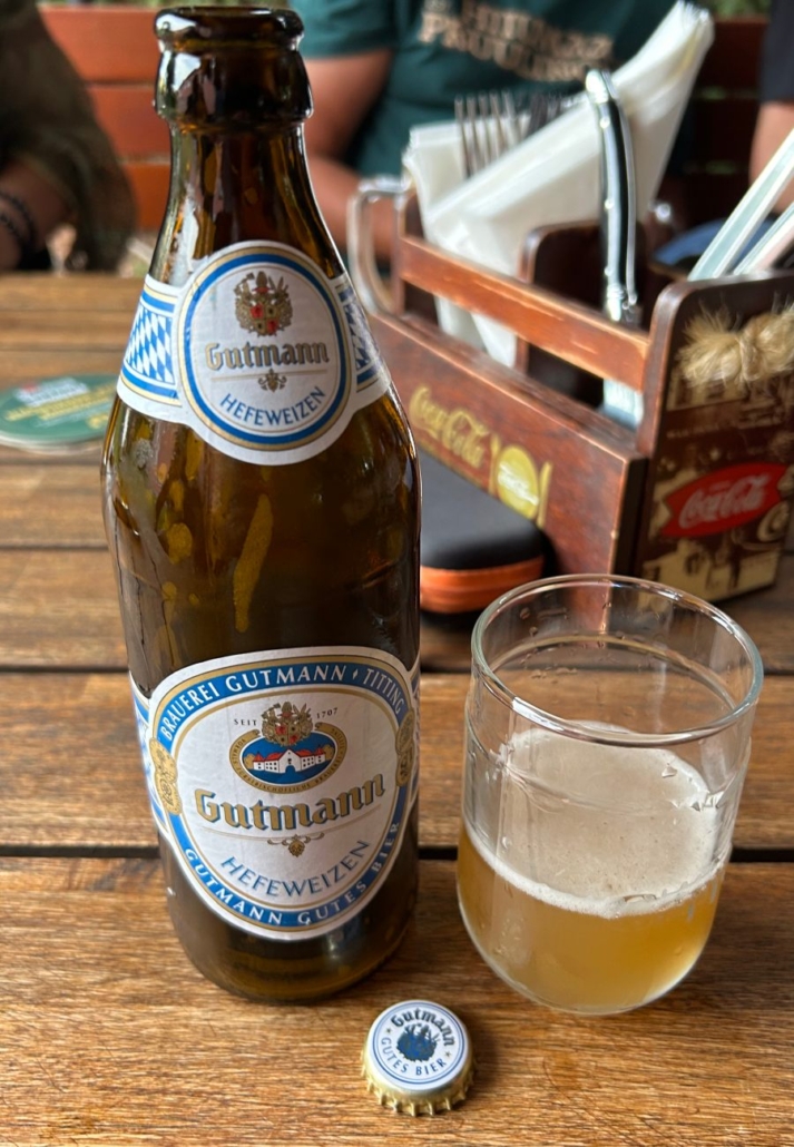 Láhev piva pšenice Gutmann Hefeweizen na stole v bavorské hospodě